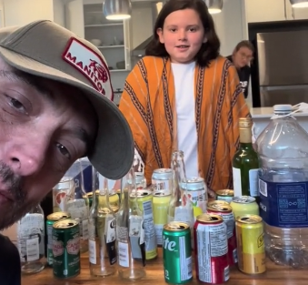 Un homme et une fille autour de contenants consignés